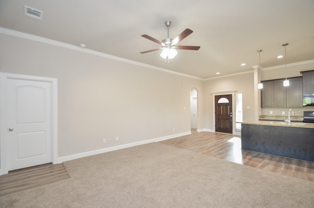 6523 Tuskegee St, Houston, TX 77091 - kitchen featuring white microwave, light colored carpet, ornamental molding, baseboards, and ceiling fan