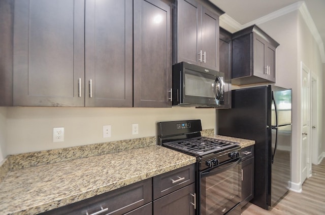 6523 Tuskegee St, Houston, TX 77091 - kitchen featuring black appliances, light wood finished floors, ornamental molding, dark brown cabinetry, and light stone countertops
