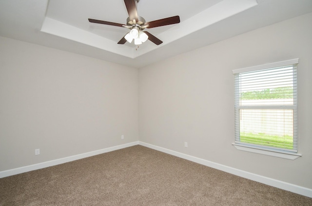 6523 Tuskegee St, Houston, TX 77091 - empty room featuring carpet, a raised ceiling, baseboards, and ceiling fan