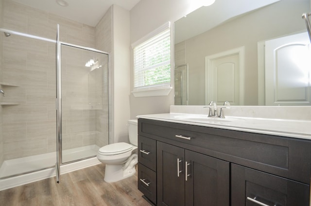 6523 Tuskegee St, Houston, TX 77091 - bathroom with vanity, toilet, a stall shower, and wood finished floors