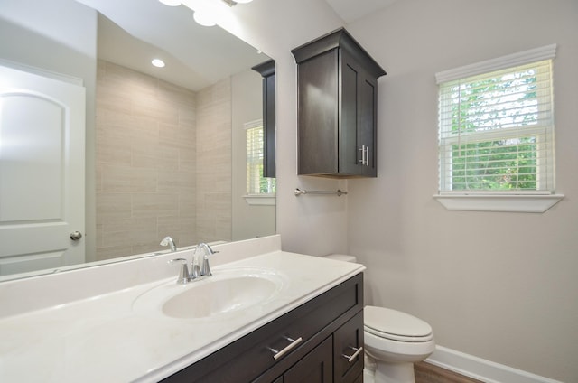 6523 Tuskegee St, Houston, TX 77091 - bathroom featuring vanity, toilet, baseboards, and wood finished floors