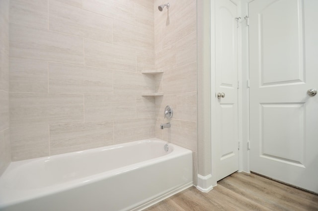 6523 Tuskegee St, Houston, TX 77091 - bathroom featuring wood finished floors and tub / shower combination