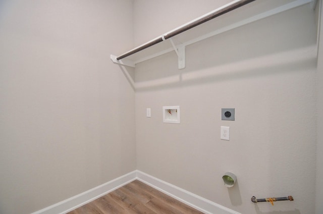 6523 Tuskegee St, Houston, TX 77091 - laundry room featuring hookup for an electric dryer, washer hookup, baseboards, wood finished floors, and gas dryer hookup