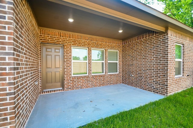6523 Tuskegee St, Houston, TX 77091 - doorway to property with brick siding and a patio