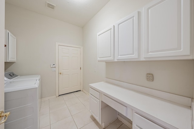 14 Devon Mill Pl, The Woodlands, TX 77382 - laundry area featuring cabinet space, independent washer and dryer, light tile patterned floors, and baseboards