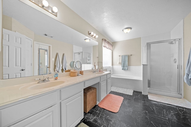 1802 Moston Dr, Spring, TX 77386 - full bathroom with double vanity, a bath, a shower stall, a textured ceiling, and marble look tiles