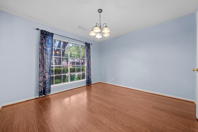 1802 Moston Dr, Spring, TX 77386 - empty room featuring a chandelier, wood finished floors, and baseboards