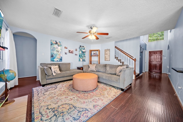 1802 Moston Dr, Spring, TX 77386 - living room with arched walkways, wood finished floors, stairway, a ceiling fan, and a textured ceiling