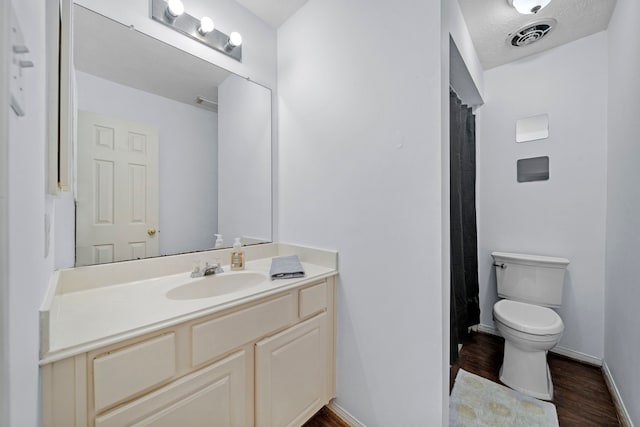 1802 Moston Dr, Spring, TX 77386 - full bathroom with vanity, toilet, wood finished floors, baseboards, and a shower with curtain