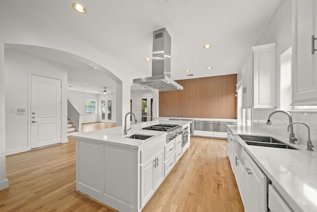 9714 Braesmont Dr, Houston, TX 77096 - kitchen featuring island range hood, a sink, recessed lighting, a ceiling fan, and a center island with sink