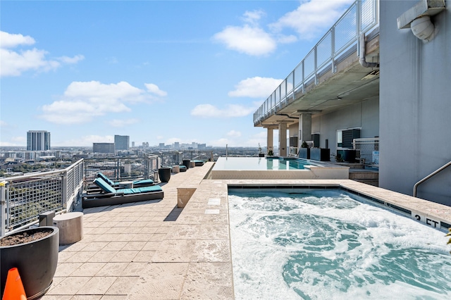 2000 Bagby St Unit 13430, Houston, TX 77002 - community pool with a hot tub, a view of skyline, and a patio