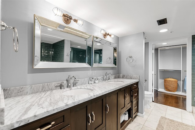 2000 Bagby St Unit 13430, Houston, TX 77002 - bathroom featuring double vanity, toilet, tile patterned flooring, and a tile shower