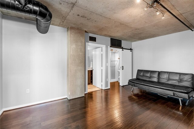 2000 Bagby St Unit 13430, Houston, TX 77002 - living area with hardwood / wood-style floors, a barn door, baseboards, and rail lighting