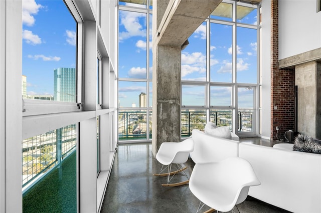 2000 Bagby St Unit 13430, Houston, TX 77002 - sunroom featuring a towering ceiling, concrete floors, a city view, and floor to ceiling windows