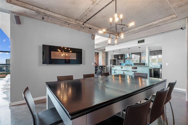 2000 Bagby St Unit 13430, Houston, TX 77002 - dining room featuring track lighting, a chandelier, baseboards, and concrete floors
