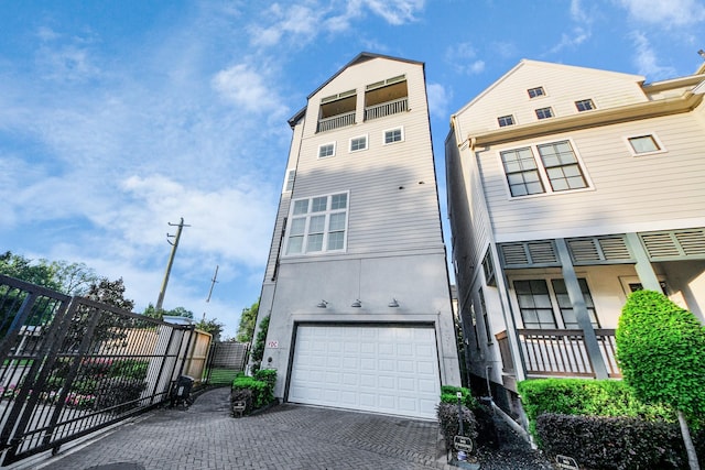 4005 Woodshire Village Ests, Houston, TX 77025 - view of front of property with a garage, decorative driveway, stucco siding, and a gate