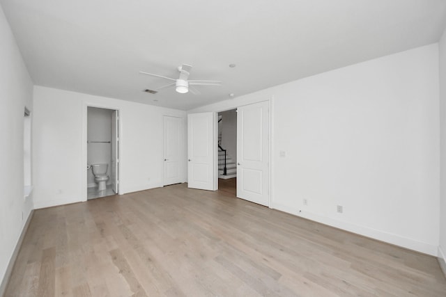 4005 Woodshire Village Ests, Houston, TX 77025 - unfurnished bedroom featuring light wood finished floors, baseboards, connected bathroom, and ceiling fan