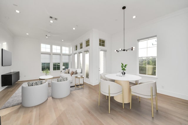 4005 Woodshire Village Ests, Houston, TX 77025 - dining room with ornamental molding, light wood-style floors, recessed lighting, baseboards, and a chandelier