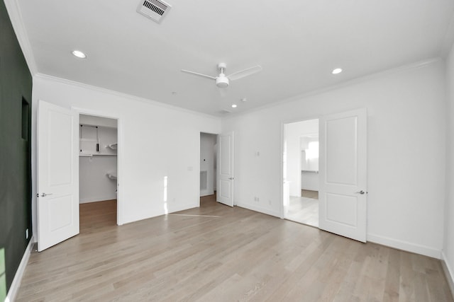 4005 Woodshire Village Ests, Houston, TX 77025 - unfurnished bedroom with crown molding, light wood finished floors, recessed lighting, baseboards, and a spacious closet