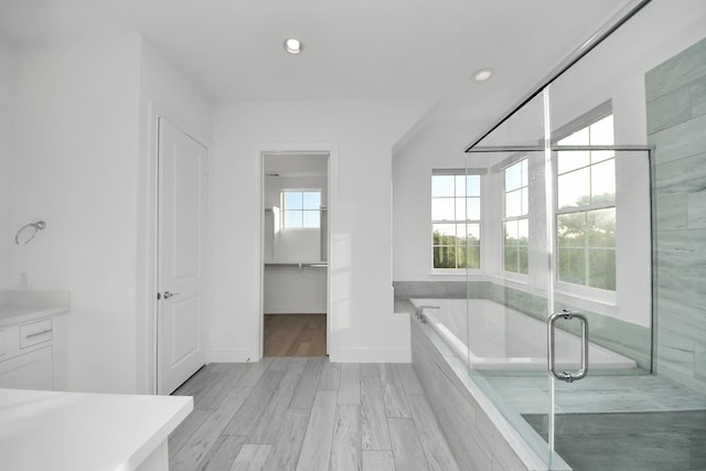 4005 Woodshire Village Ests, Houston, TX 77025 - full bathroom with a bath, vanity, recessed lighting, a closet, and wood finished floors