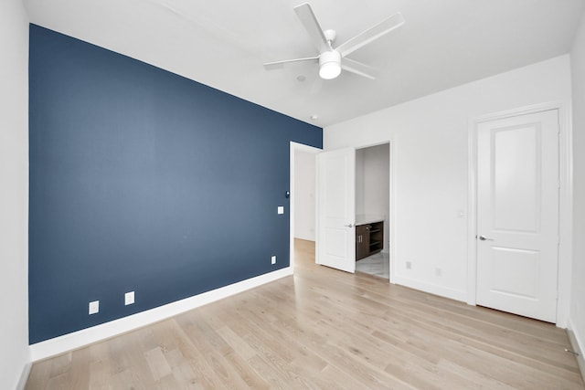 4005 Woodshire Village Ests, Houston, TX 77025 - unfurnished bedroom featuring baseboards, light wood-style flooring, and ceiling fan