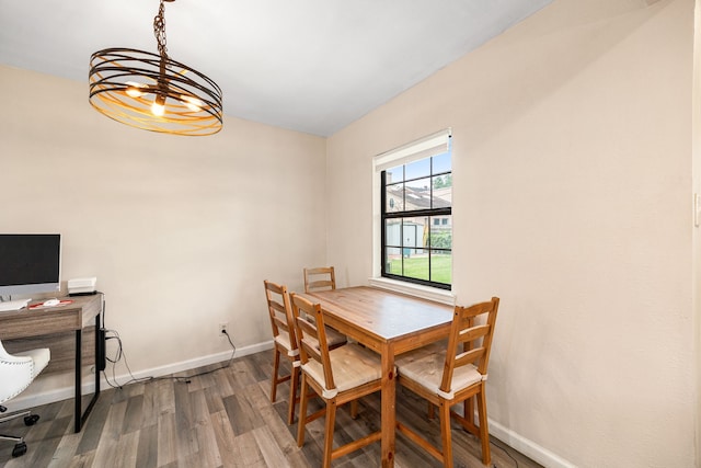 2915 Robertson St, Houston, TX 77009 - dining area with wood finished floors, baseboards, and a chandelier