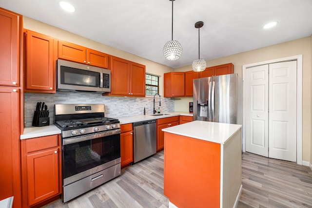 2915 Robertson St, Houston, TX 77009 - kitchen featuring stainless steel appliances, a sink, light countertops, tasteful backsplash, and light wood-style floors