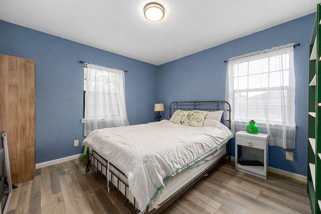 2915 Robertson St, Houston, TX 77009 - bedroom with multiple windows, wood finished floors, and baseboards