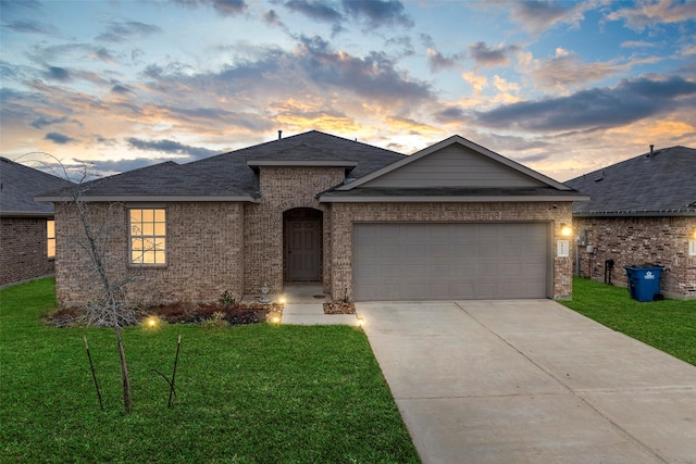 18693 Swainboro Dr, New Caney, TX 77357 - view of front of property featuring a yard, an attached garage, driveway, and brick siding
