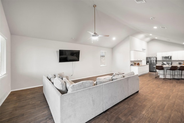 18693 Swainboro Dr, New Caney, TX 77357 - living room with dark wood-type flooring, ceiling fan, baseboards, recessed lighting, and high vaulted ceiling