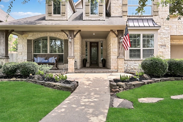 1013 Bolivar Point Ln, Friendswood, TX 77546 - entrance to property with covered porch, stone siding, a yard, and a shingled roof