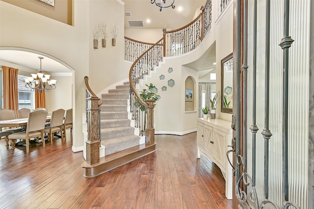 1013 Bolivar Point Ln, Friendswood, TX 77546 - foyer with a chandelier, a towering ceiling, plenty of natural light, arched walkways, and stairs