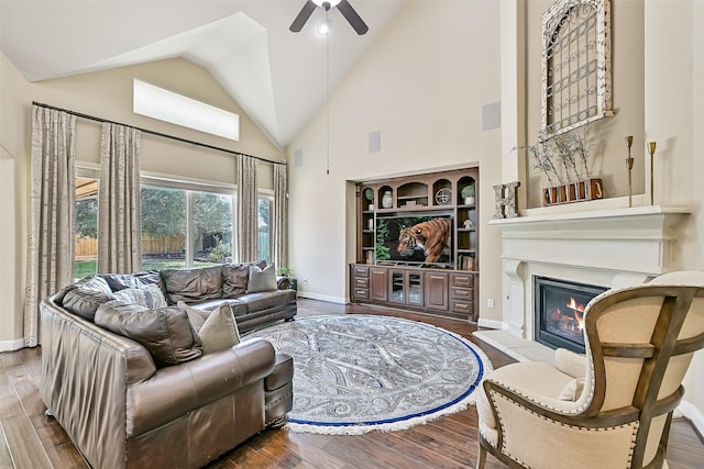 1013 Bolivar Point Ln, Friendswood, TX 77546 - living room with ceiling fan, high vaulted ceiling, a glass covered fireplace, wood finished floors, and baseboards