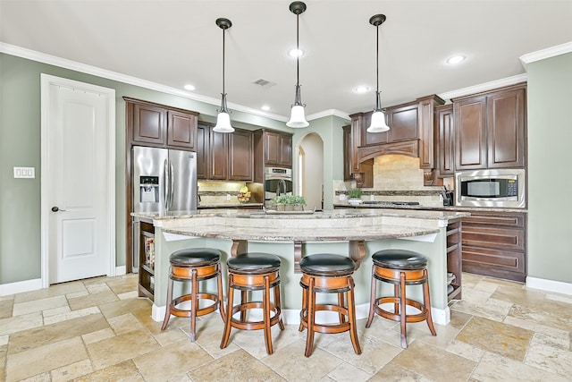 1013 Bolivar Point Ln, Friendswood, TX 77546 - kitchen featuring stainless steel appliances, crown molding, baseboards, stone tile floors, and recessed lighting