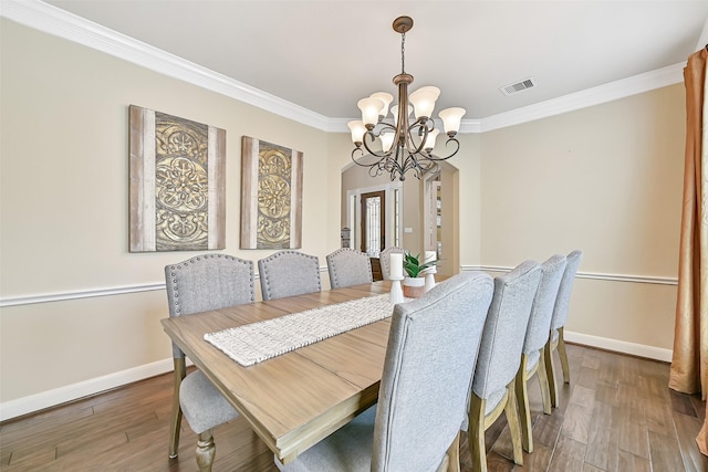 1013 Bolivar Point Ln, Friendswood, TX 77546 - dining space featuring a chandelier, ornamental molding, baseboards, and wood-type flooring