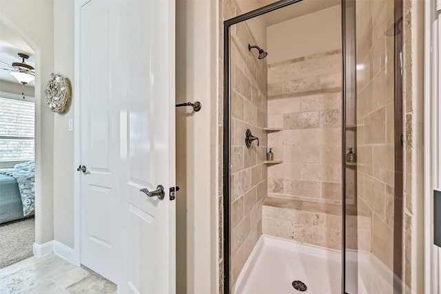 1013 Bolivar Point Ln, Friendswood, TX 77546 - bathroom with a stall shower, connected bathroom, baseboards, and ceiling fan