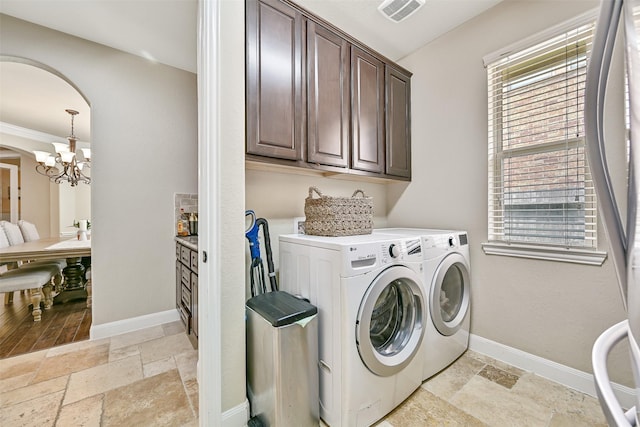 1013 Bolivar Point Ln, Friendswood, TX 77546 - laundry room with cabinet space, separate washer and dryer, stone tile flooring, and a chandelier