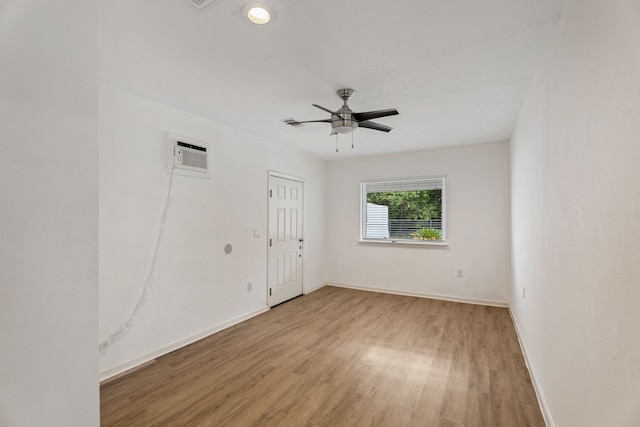 6414 Crestridge St, Houston, TX 77033 - empty room with baseboards, wood finished floors, ceiling fan, and a wall mounted air conditioner