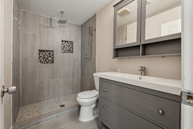 6414 Crestridge St, Houston, TX 77033 - full bathroom with vanity, toilet, tiled shower, and a textured ceiling