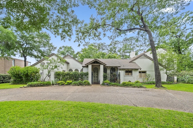 14119 Kiamesha Ct, Houston, TX 77069 - view of front of house featuring a chimney, a tiled roof, and stucco siding