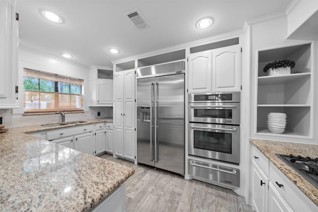 14119 Kiamesha Ct, Houston, TX 77069 - kitchen with stainless steel appliances, a sink, a warming drawer, open shelves, and white cabinets