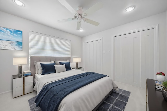 14119 Kiamesha Ct, Houston, TX 77069 - bedroom with multiple closets, light carpet, ceiling fan, recessed lighting, and baseboards