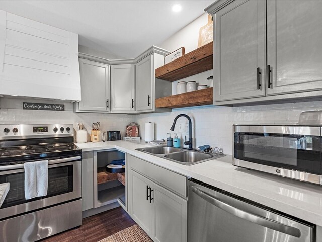 14510 Henry Calfee Dr, Willis, TX 77318 - kitchen with stainless steel appliances, open shelves, a sink, light countertops, and tasteful backsplash