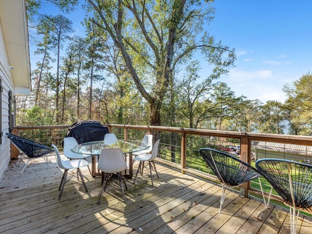 14510 Henry Calfee Dr, Willis, TX 77318 - wooden deck featuring outdoor dining space and grilling area