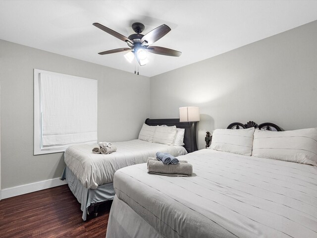 14510 Henry Calfee Dr, Willis, TX 77318 - bedroom featuring dark wood finished floors, baseboards, and ceiling fan