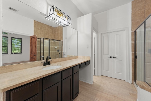 28411 Calaveras Creek Ct, Houston, TX 77336 - bathroom with vanity, a stall shower, and wood finished floors