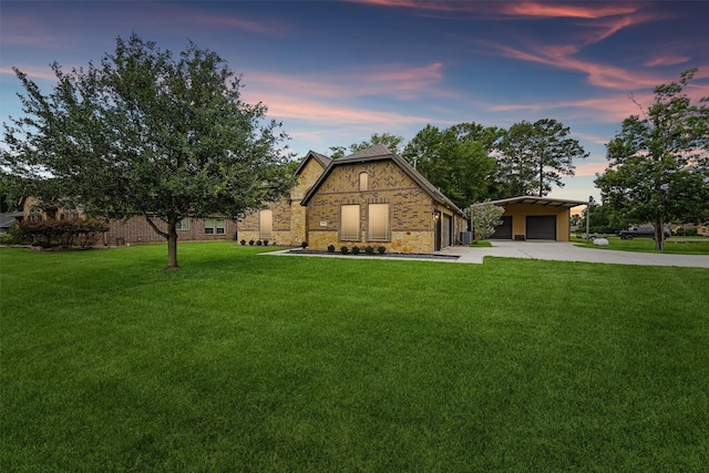 28411 Calaveras Creek Ct, Houston, TX 77336 - view of front facade with driveway, a yard, a detached garage, and stone siding