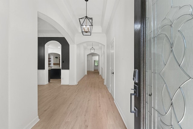 28411 Calaveras Creek Ct, Houston, TX 77336 - entryway featuring arched walkways, light wood-style floors, baseboards, and crown molding