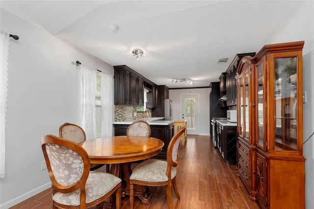 2639 Cypress Island Dr, Houston, TX 77073 - dining space with dark wood-type flooring, baseboards, and track lighting