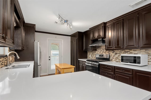 2639 Cypress Island Dr, Houston, TX 77073 - kitchen with stainless steel appliances, a sink, under cabinet range hood, and light countertops